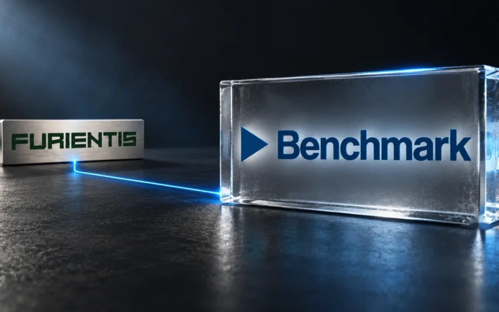 Etched-glass Benchmark logo joined by a thin blue line to a Furientis nameplate on a dark graphite surface